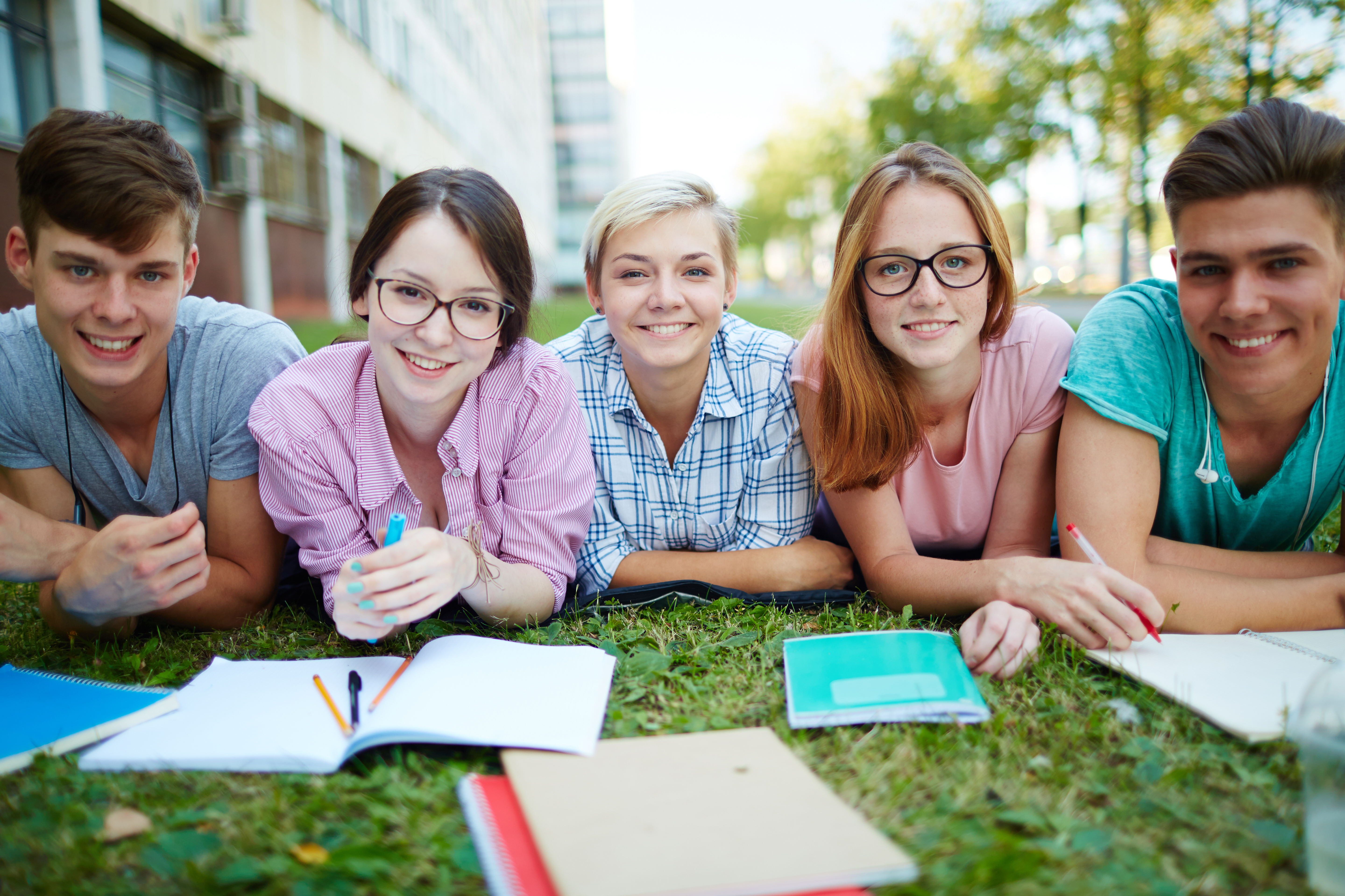 Students look at their. Летняя школа. Летняя учеба. Студенты на улице летом. Трава у школы.